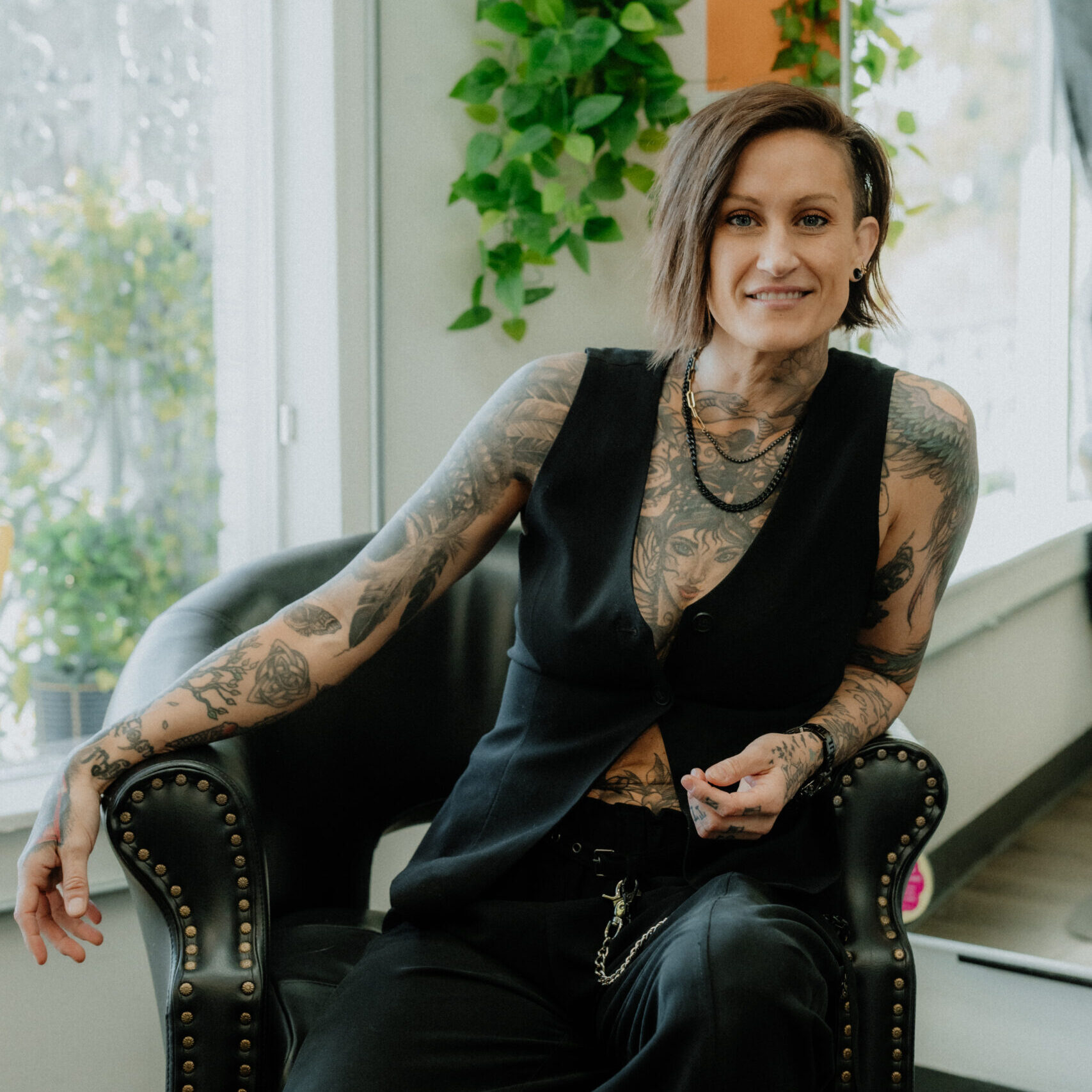 Keenan, founder and short hair specialist at Keenan Salon, confidently standing in the colorful Atlanta salon.