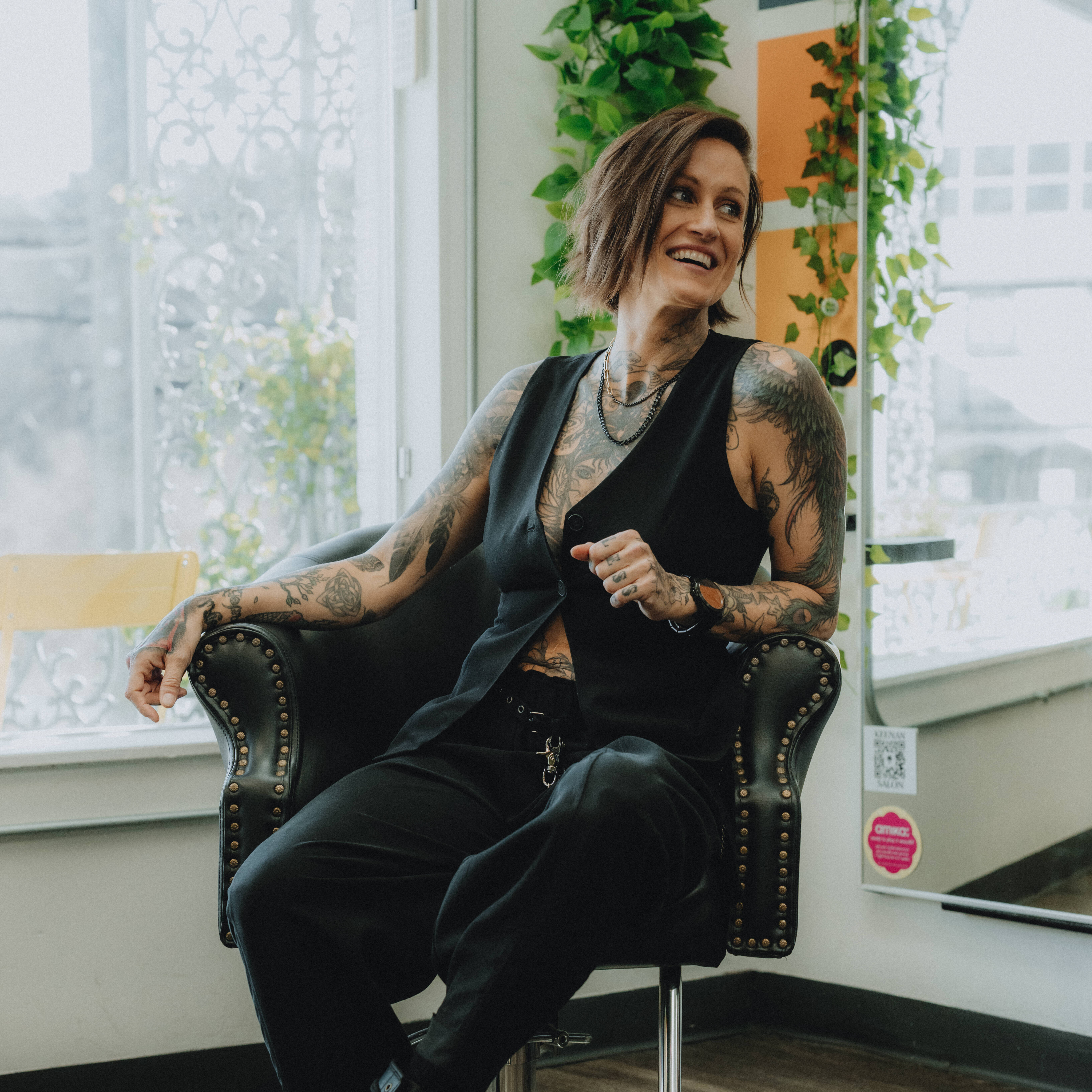 Keenan, founder and short hair specialist at Keenan Salon, confidently standing in the colorful Atlanta salon.
